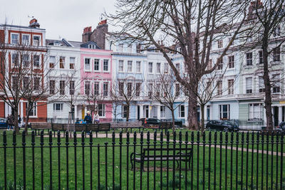 Houses and trees in city against sky