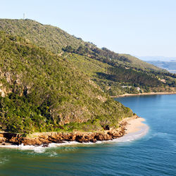 Scenic view of sea and mountains against sky