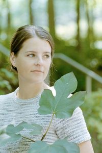 Portrait of woman against plants