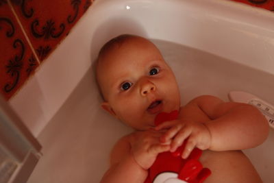 High angle portrait of baby boy in bathtub