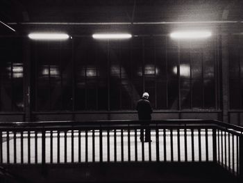 Woman standing in illuminated city at night