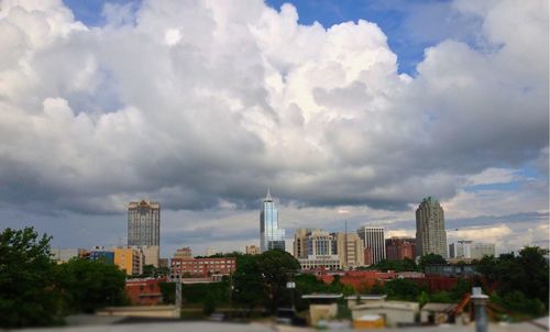 Skyscrapers against cloudy sky