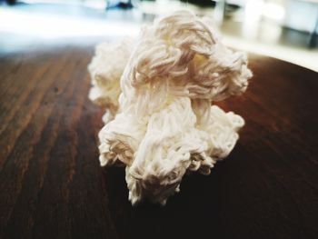 Close-up of teddy bear on wooden table