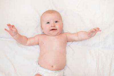 Portrait of cute baby boy against white background