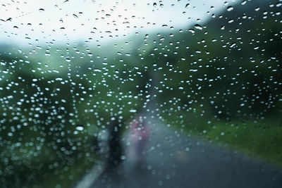 Full frame shot of wet glass window in rainy season