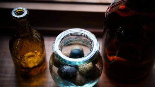 Close-up of glass containers on windowsill