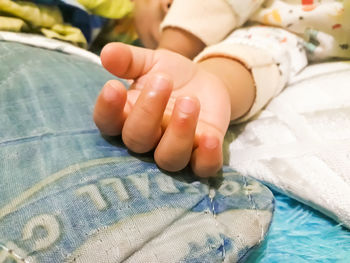 Close-up of baby lying on bed