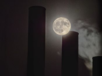 Low angle view of illuminated lamp against sky at night