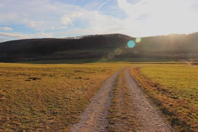 Road amidst landscape against sky