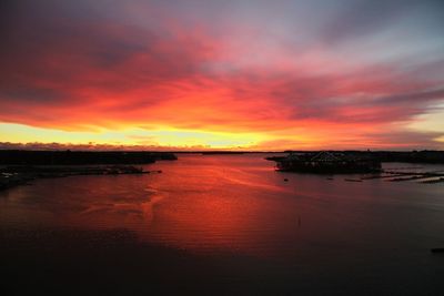 Scenic view of sea against cloudy sky during sunset