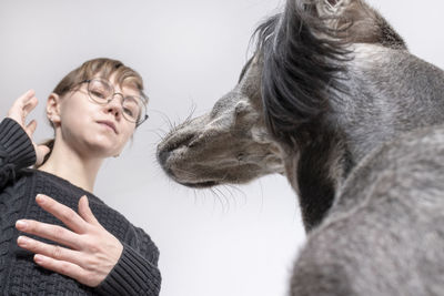 Low angle view of dog woman against ceilin