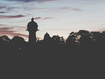 Silhouette of clock tower against sky during sunset