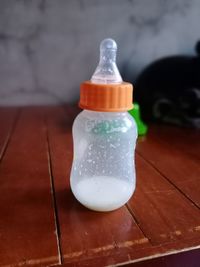Close-up of wet glass bottle on table