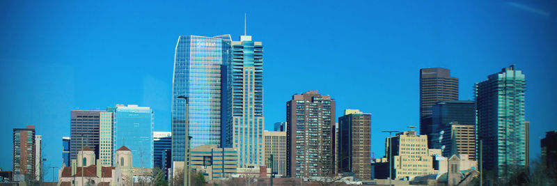 Modern buildings in denver colorado against blue sky