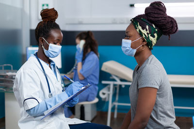 Female doctor examining patient in hospital