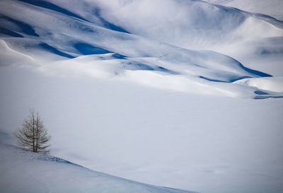 Scenic view of snow covered mountains against sky