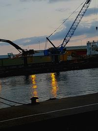 Scenic view of harbor against sky during sunset