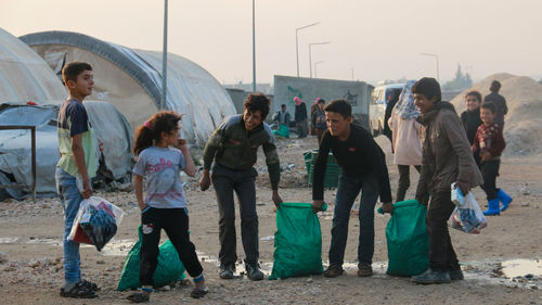 Rear view of people standing outdoors