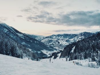 Scenic view of snow covered mountains against sky