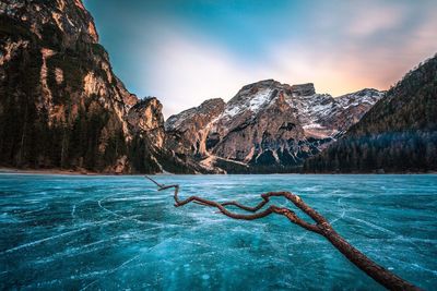 Scenic view frozen lake against mountain landscape