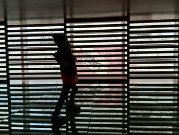 Full length of woman standing on tiled floor