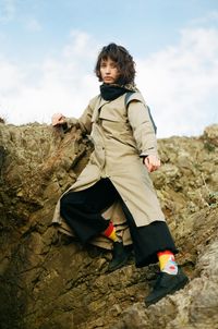 Full length of woman on rock against sky