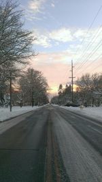 Road passing through bare trees