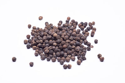 High angle view of coffee beans against white background