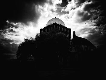 Low angle view of building against cloudy sky