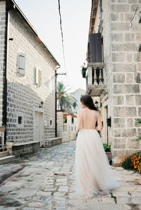 Rear view of woman walking on street