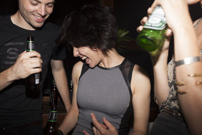 Midsection of a young man drinking glass