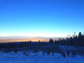 Scenic view of landscape against clear blue sky during winter