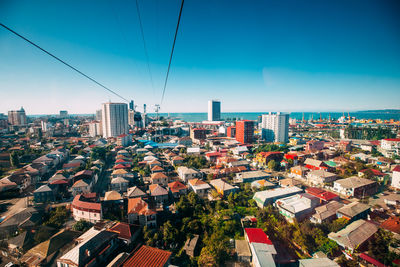 High angle view of buildings against blue sky