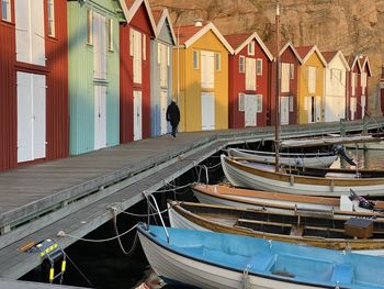 Rear view of man on boat moored by building