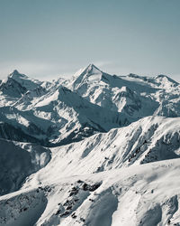 Scenic view of snow covered mountains against sky