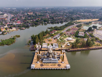 High angle view of crystal mosque by river 