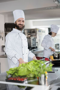 Portrait of smiling female doctor standing in kitchen