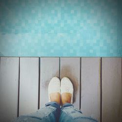 Low section of woman standing on tiled floor