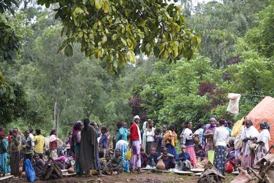 Group of people against plants