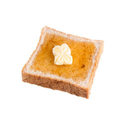 Close-up of cake on plate against white background