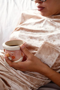 Portrait of woman using mobile phone on bed at home