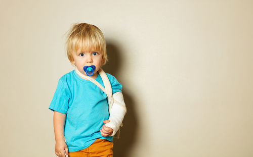 Portrait of boy with toy against white background