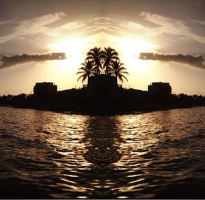 Scenic view of river against sky at sunset