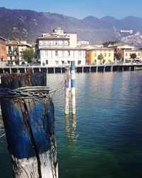 Houses by sea against sky