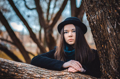 Portrait of beautiful young woman in forest