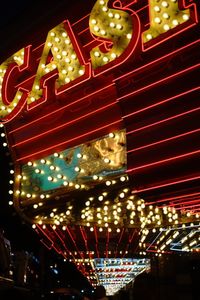 Low angle view of illuminated ferris wheel at night