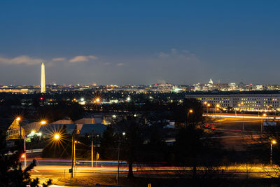 High angle view of illuminated city against sky at night