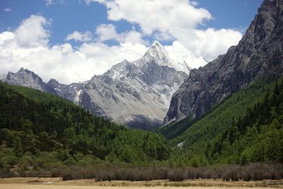 Scenic view of mountains against cloudy sky