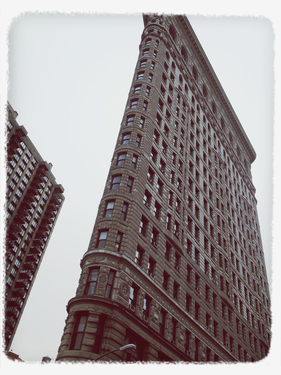 transfer print, architecture, building exterior, built structure, auto post production filter, low angle view, tower, clear sky, building, city, sky, day, no people, outdoors, tall - high, window, pattern, history, architectural feature, facade