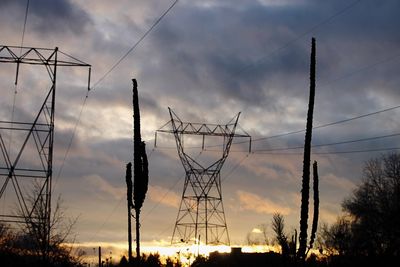 Low angle view of electricity pylon against sky